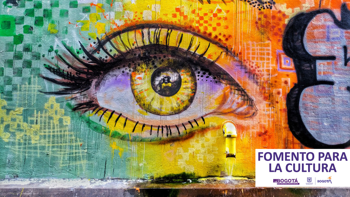 Arte urbano colorido que muestra un ojo y un texto de fomento para la cultura
