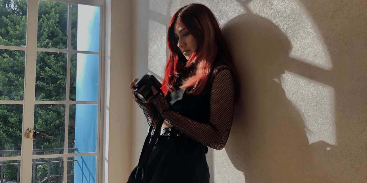 Creadora del taller con una cámara fotográfica en la mano