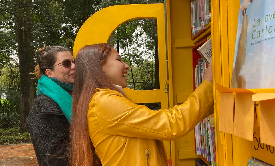 dos mujeres consultando libros en un paradero paralibro paraparque