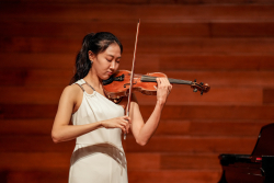 Música interpretando el violín en un teatro