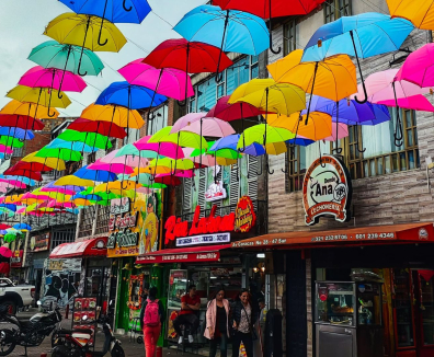 Calle de lechonerías decorada con sombrillas de colores