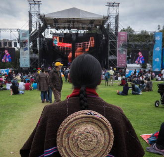 Persona indígena mirando a un escenario